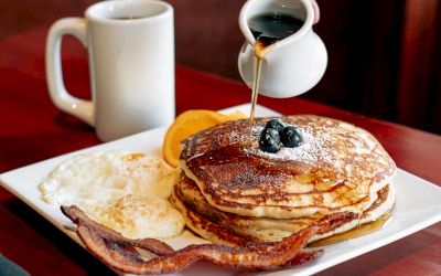 Pancakes, eggs, bacon, and coffee